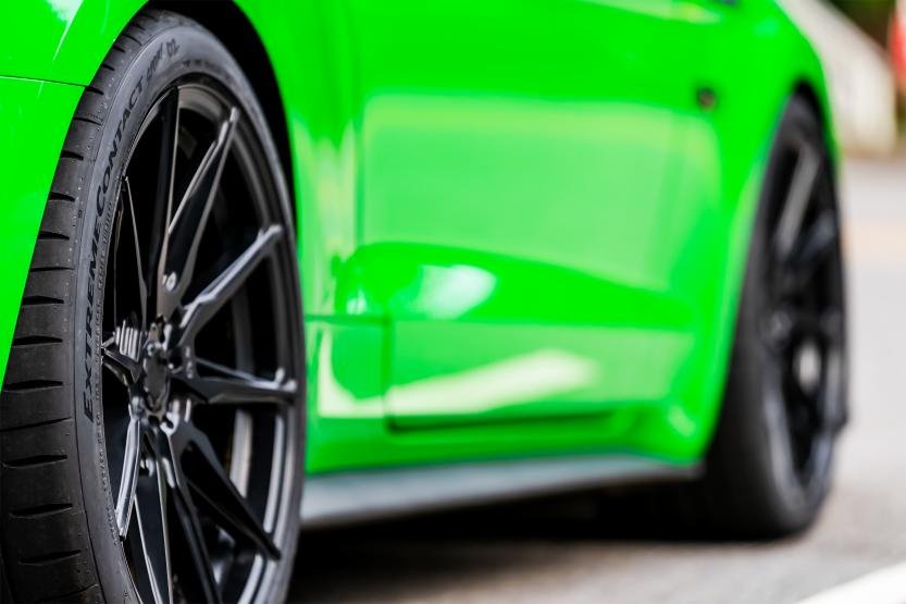 Views of Continental ExtremeContact Sport02 tire on a green car.